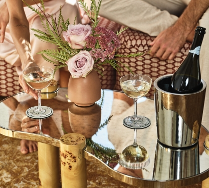Close up of a bottle of wine and glasses sitting on a table