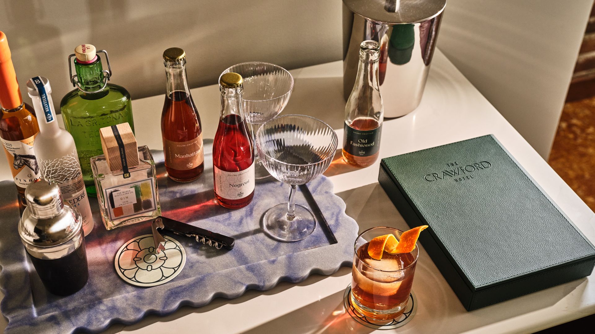 A bar cart with an assortment of ingredients.
