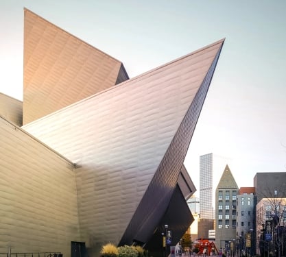 Exterior of Denver Art Museum, skyline in background in Denver, Colorado.