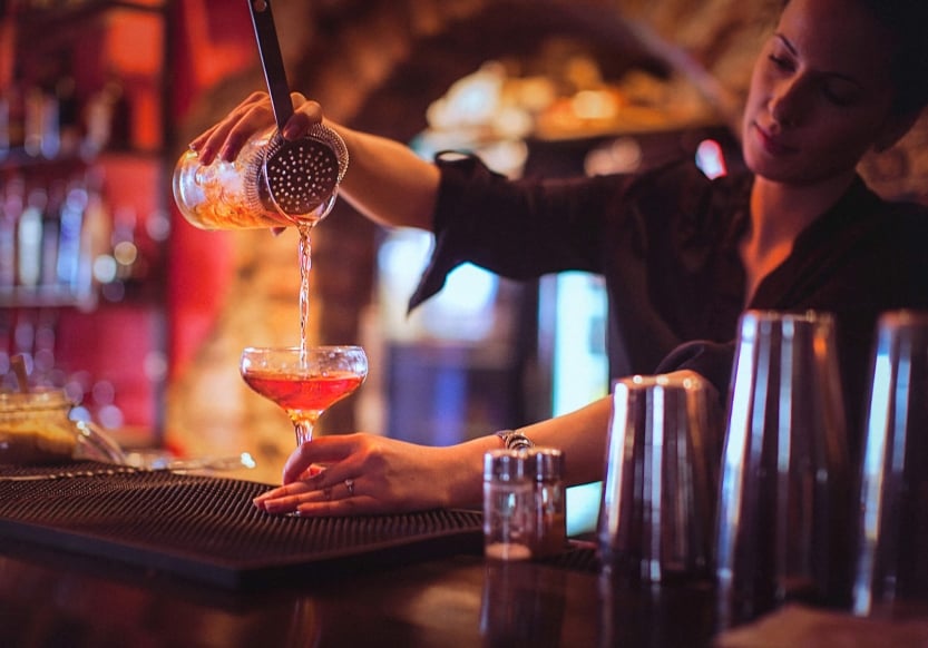 A bartender pouring a cocktail at The Cruise Room in Denver, Colorado.