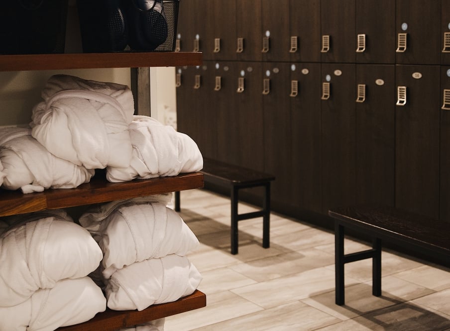 A locker room with robes on a shelf
