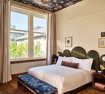 A king bed in the Deluxe Classic Guest Room at the Crawford Hotel in Denver, Colorado.