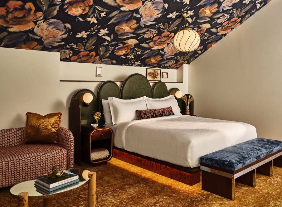Queen bed and chaise lounge in the LoDo Suite at the Crawford Hotel in Denver, Colorado.