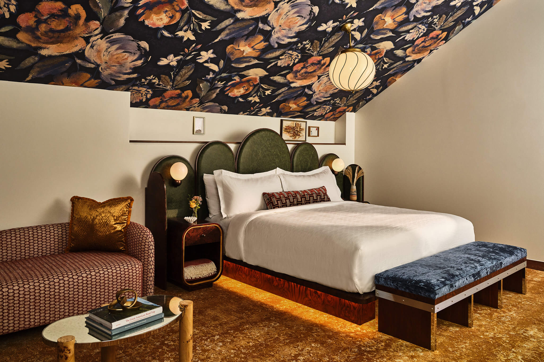 Queen bed and chaise lounge in the LoDo Suite at the Crawford Hotel in Denver, Colorado.