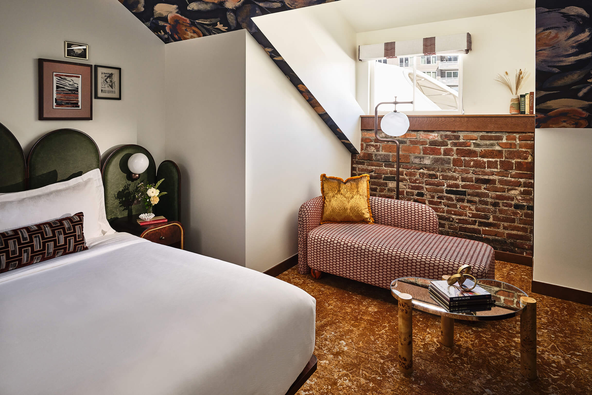 Bed and chaise lounge in the Superior Loft Guest Room at the Crawford Hotel in Denver, Colorado.