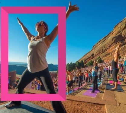 A group of people doing yoga at Red Rocks Amphitheatre at sunrise in Denver, Colorado.