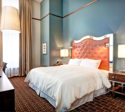 A king bed in a hotel room.