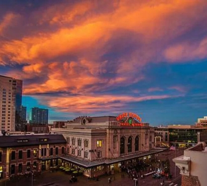 The exterior of union station with a dramatic blue and orange sunset in the background.