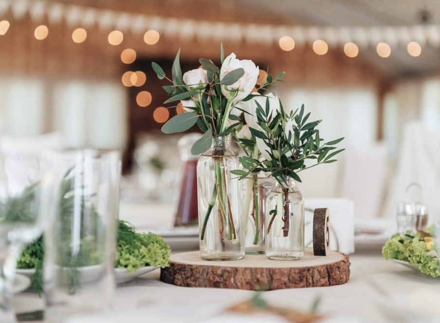 Simple bouquets of flowers on a wedding table.