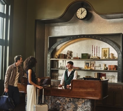 A man and woman talking to a receptionist