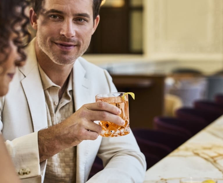 Close up of a man and a woman talking and enjoying drinks