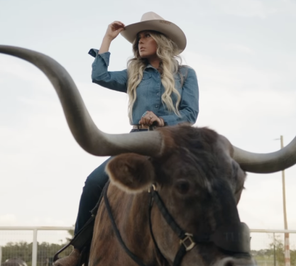 A woman riding a cow