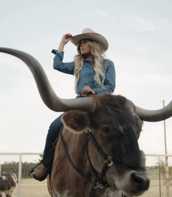 A woman riding a cow