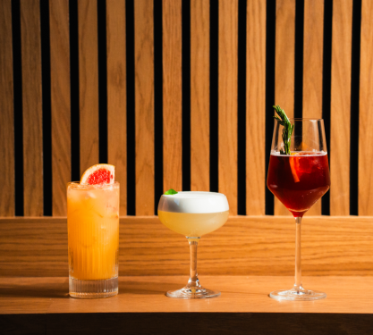Three cocktails on a table at The Crawford Hotel