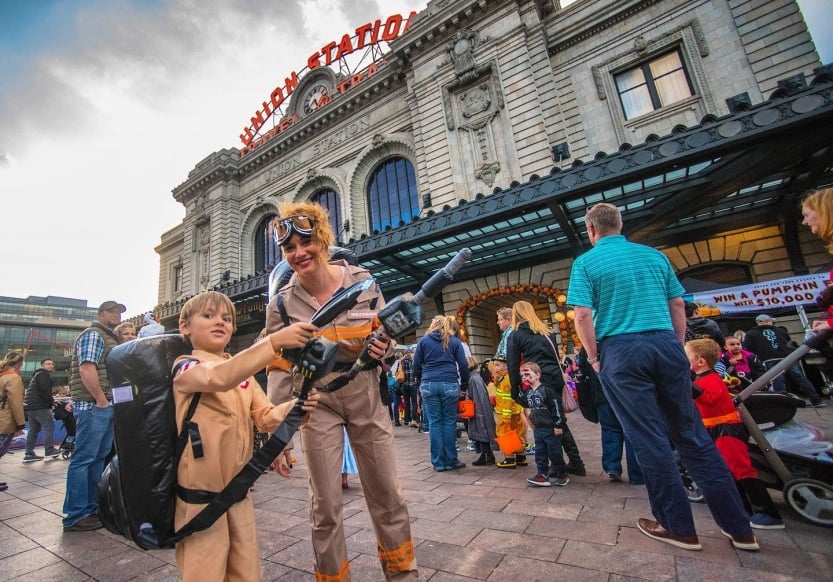 Adult and Child dressed as ghostbusters outside of Denver Union Station for the annual 