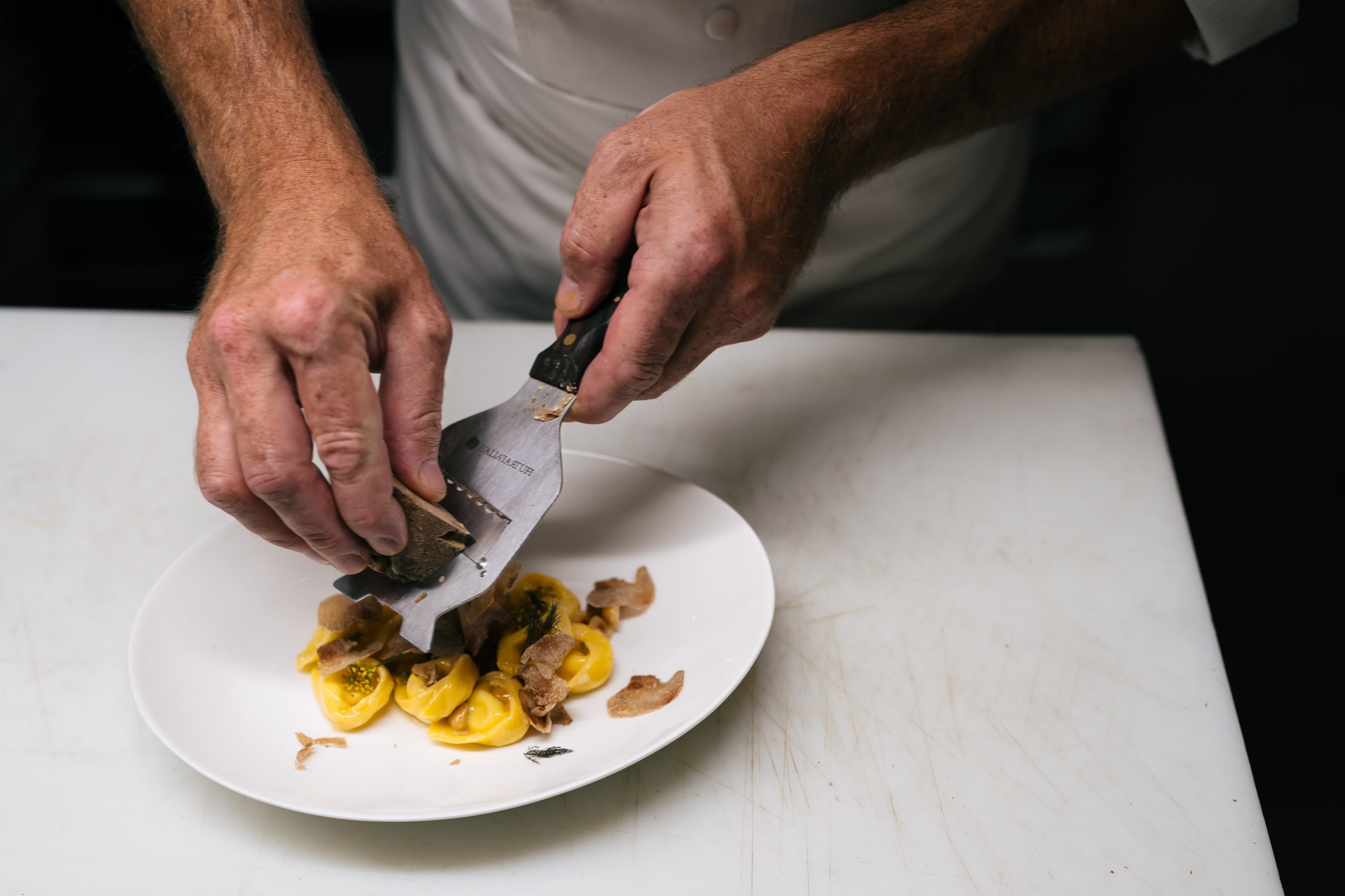 A chef preparing a dish at The Crawford Hotel