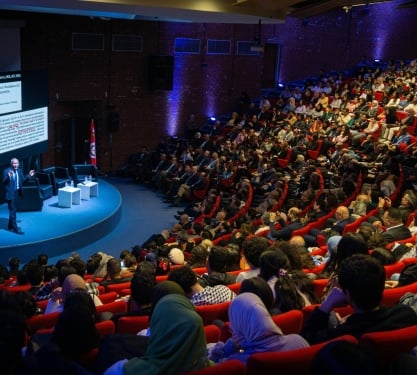 People sitting in a theatre at a conference